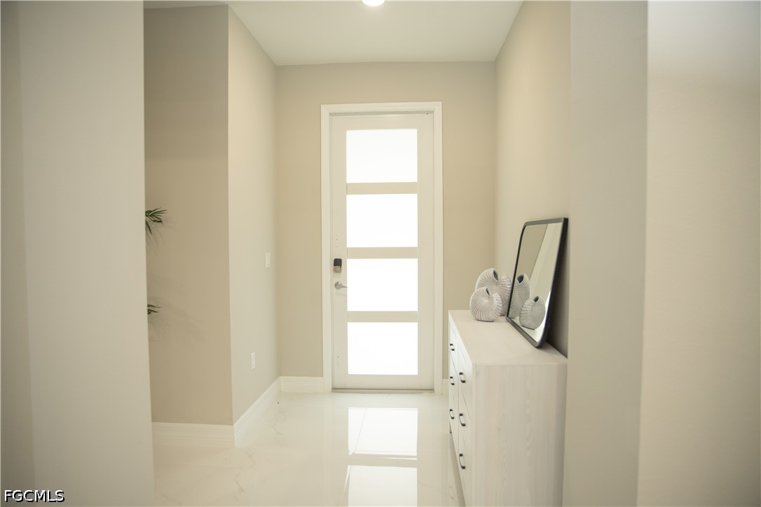 1228 Chrisholm Street Lehigh Acres, FL 33974 - Photo 2 of 18 a view of a small space with wooden floor and a window