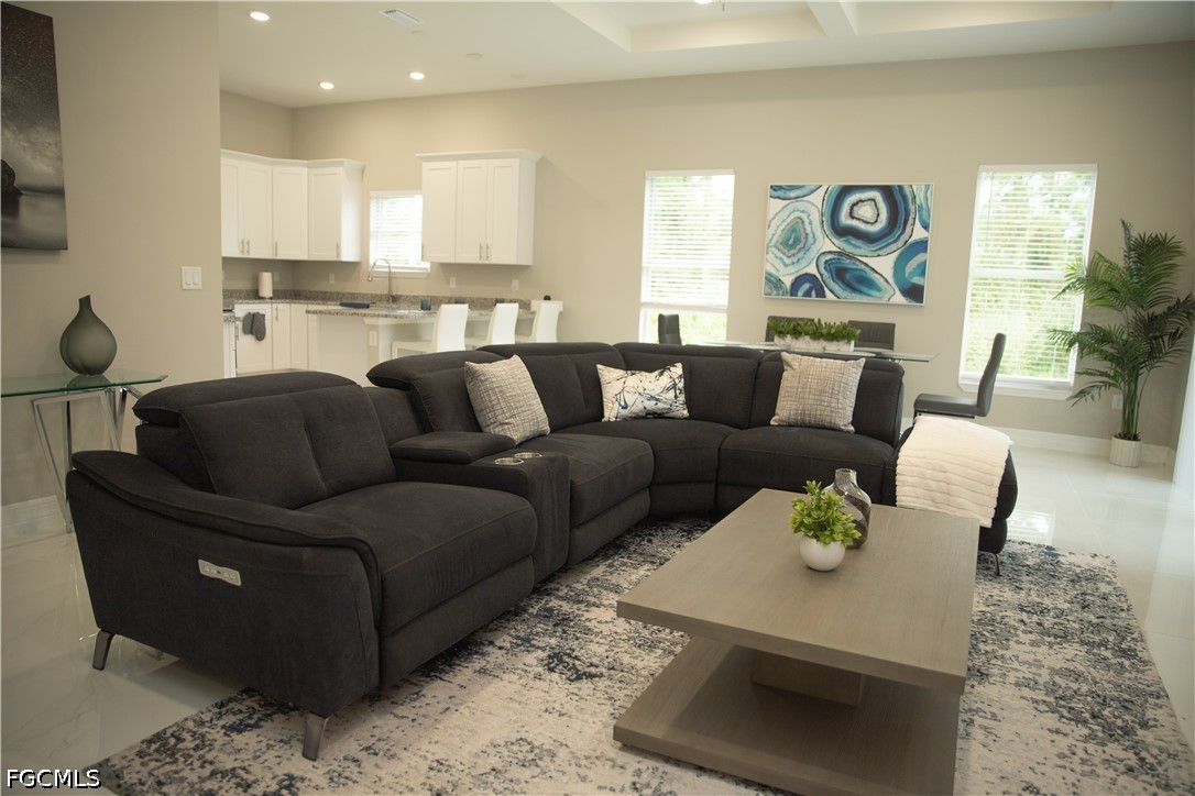 1228 Chrisholm Street Lehigh Acres, FL 33974 - Photo 4 of 18 a living room with furniture and a wooden floor