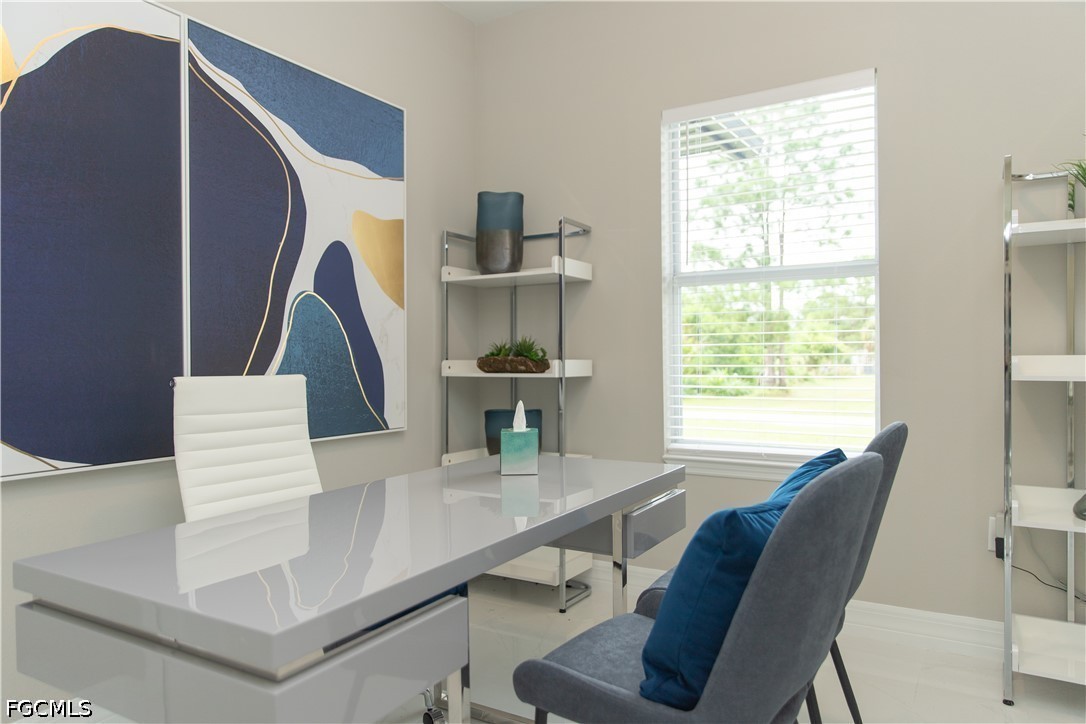 1228 Chrisholm Street Lehigh Acres, FL 33974 - Photo 6 of 18 a view of a dining room with furniture and a window