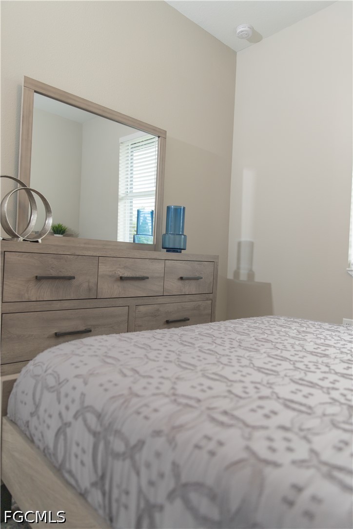 1228 Chrisholm Street Lehigh Acres, FL 33974 - Photo 10 of 18 a bedroom with a bed and a window