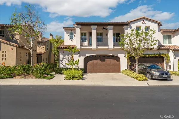 a front view of a house with a yard and a garage