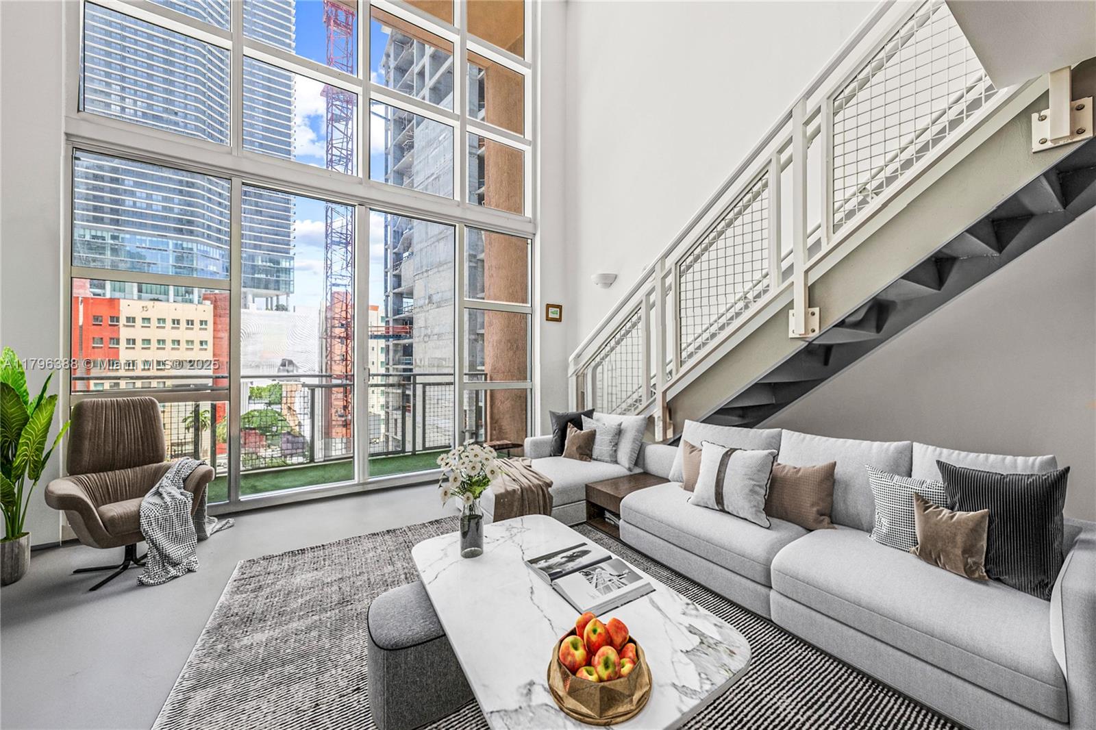 244 Biscayne Boulevard, Unit 645 Miami, FL 33132 - Photo 1 of 45 a living room with furniture and a large window