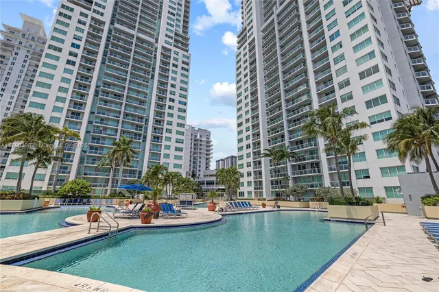 a view of swimming pool with outdoor seating and lake view