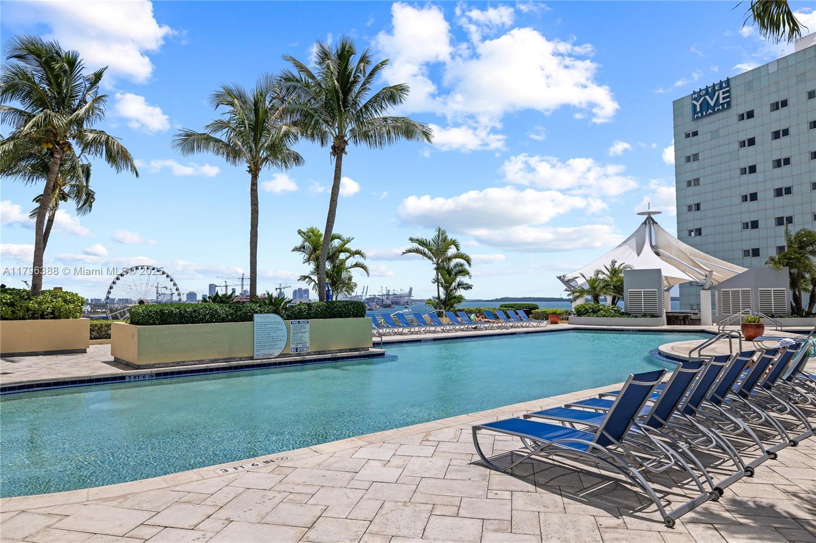 244 Biscayne Boulevard, Unit 645 Miami, FL 33132 - Photo 18 of 45 a view of a lake with a table and chairs