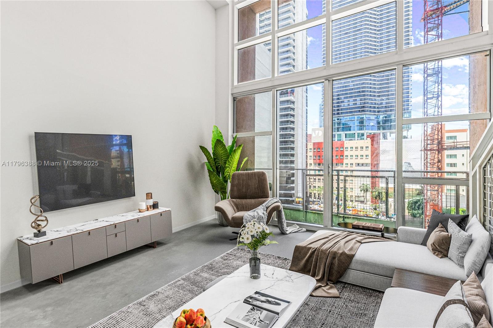 244 Biscayne Boulevard, Unit 645 Miami, FL 33132 - Photo 2 of 45 a living room with furniture and a flat screen tv