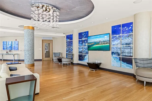 a living room with furniture and a chandelier
