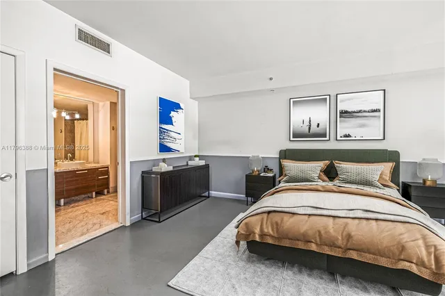 a bedroom with a bed and a view of en suite bathroom