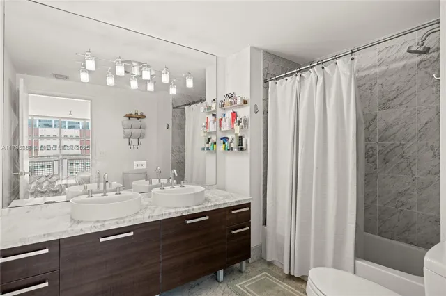 a bathroom with a sink double vanity and a mirror
