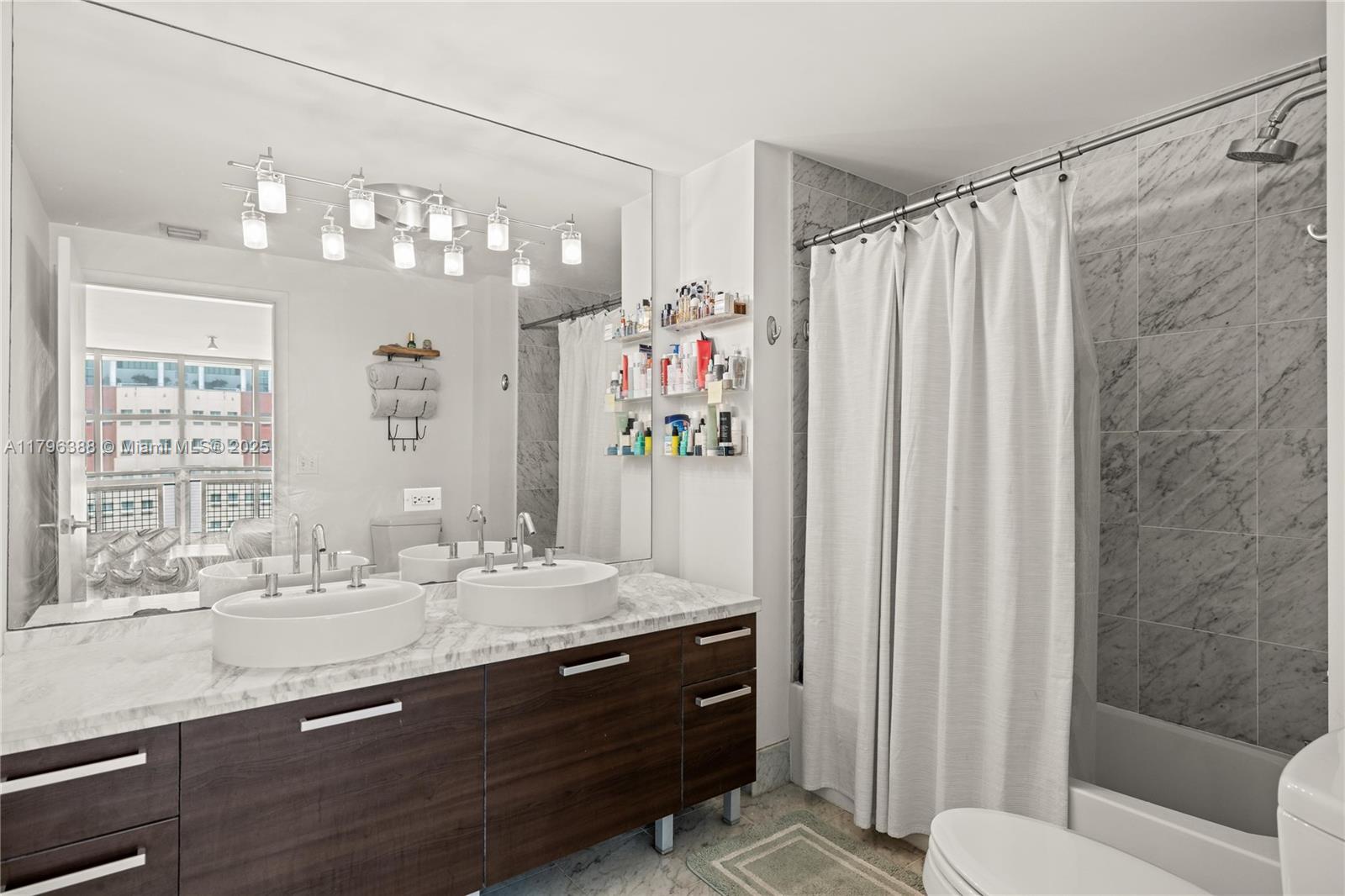 244 Biscayne Boulevard, Unit 645 Miami, FL 33132 - Photo 8 of 45 a bathroom with a sink double vanity and a mirror