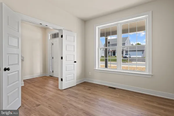 a kitchen with stainless steel appliances a refrigerator and wooden floor