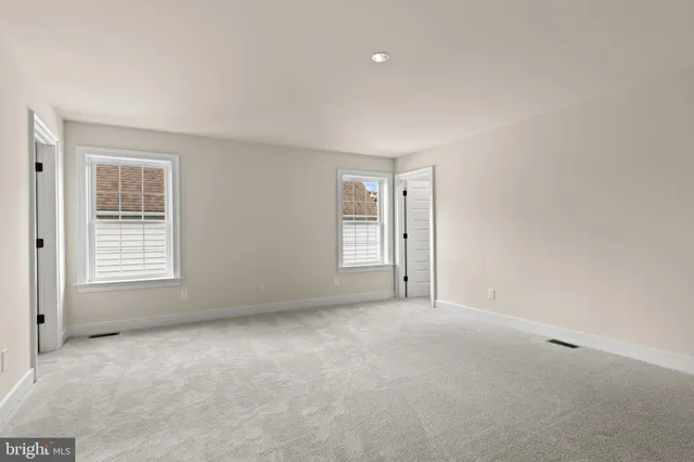 an empty room with windows and entrance