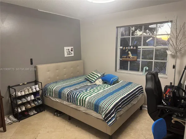 a bedroom with a bed and dresser
