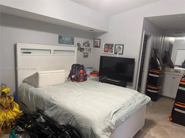 a bedroom with a bed and a flat screen tv
