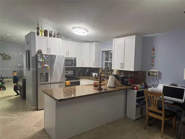 a kitchen with stainless steel appliances a sink stove and refrigerator