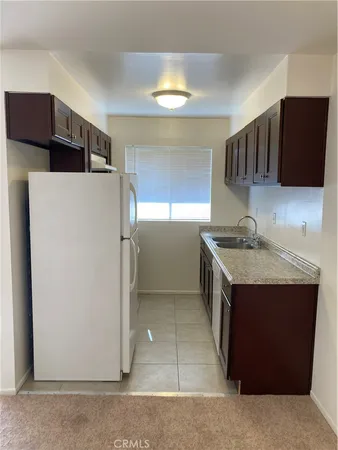 a kitchen with stainless steel appliances a refrigerator and a stove