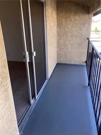 a view of empty room with refrigerator