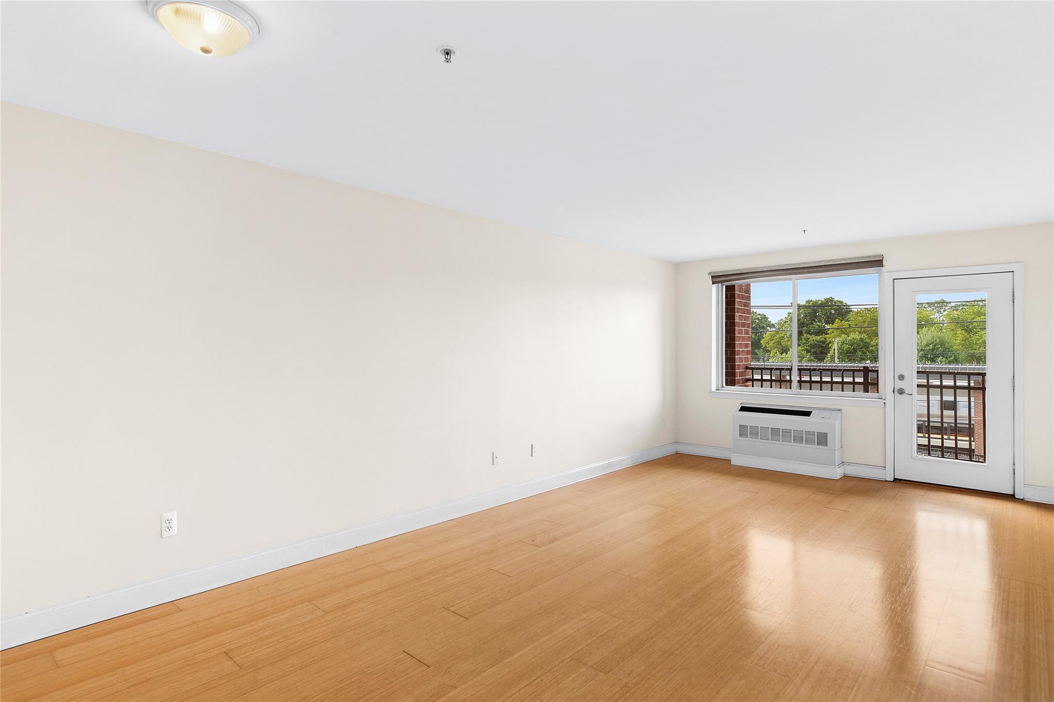 130 Post Avenue, Unit 316 Westbury, NY 11590 - Photo 5 of 15 Unfurnished room featuring light wood-style floors and baseboards