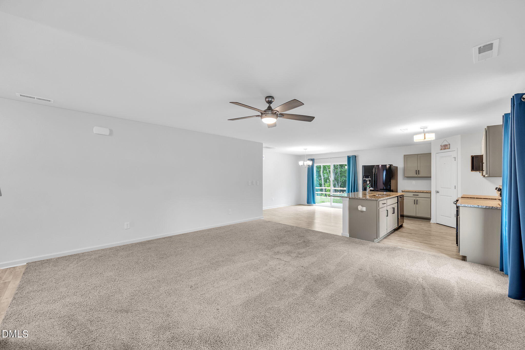 177 Yellowwood Avenue Spring Hope, NC 27882 - Photo 9 of 31 a view of a livingroom with furniture a ceiling fan and a kitchen