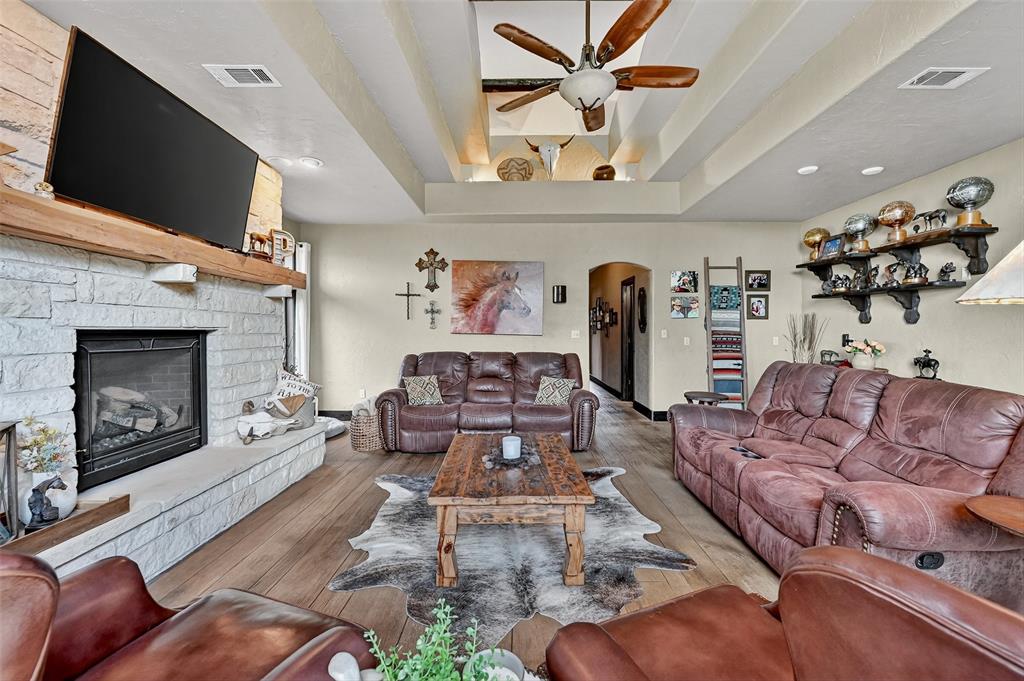 1717 Batey Road Collinsville, TX 76233 - Photo 17 of 40 a living room with furniture a flat screen tv and a fireplace