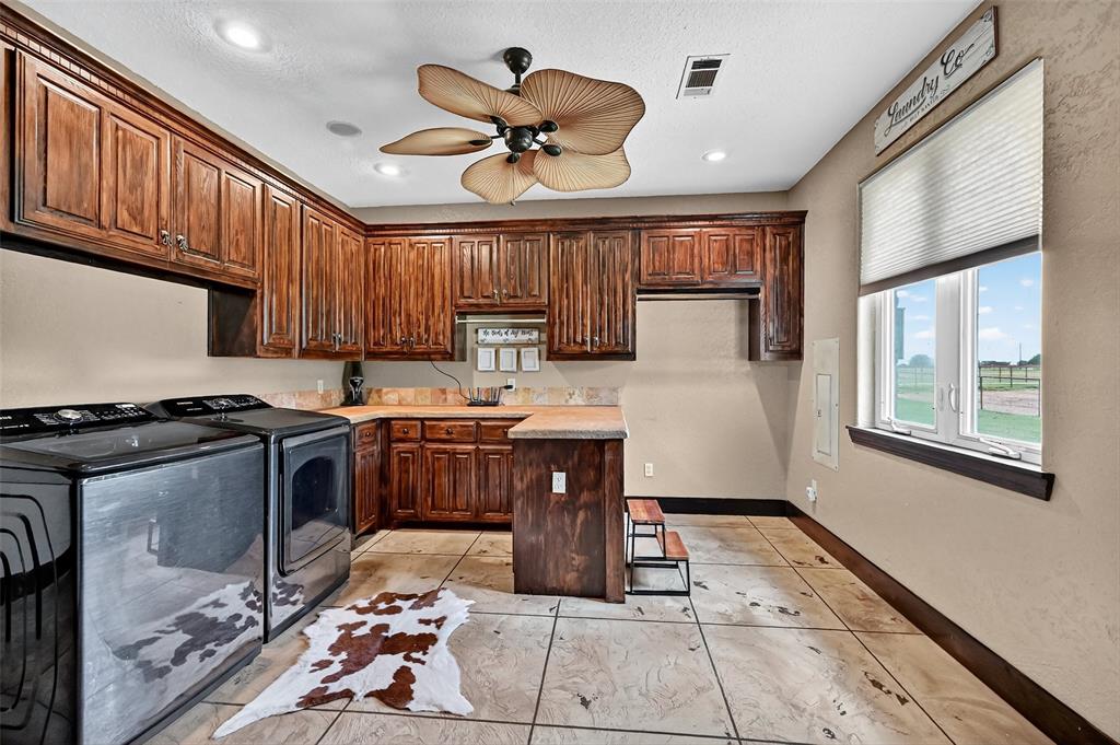 1717 Batey Road Collinsville, TX 76233 - Photo 26 of 40 a kitchen with a sink appliances cabinets and a large window