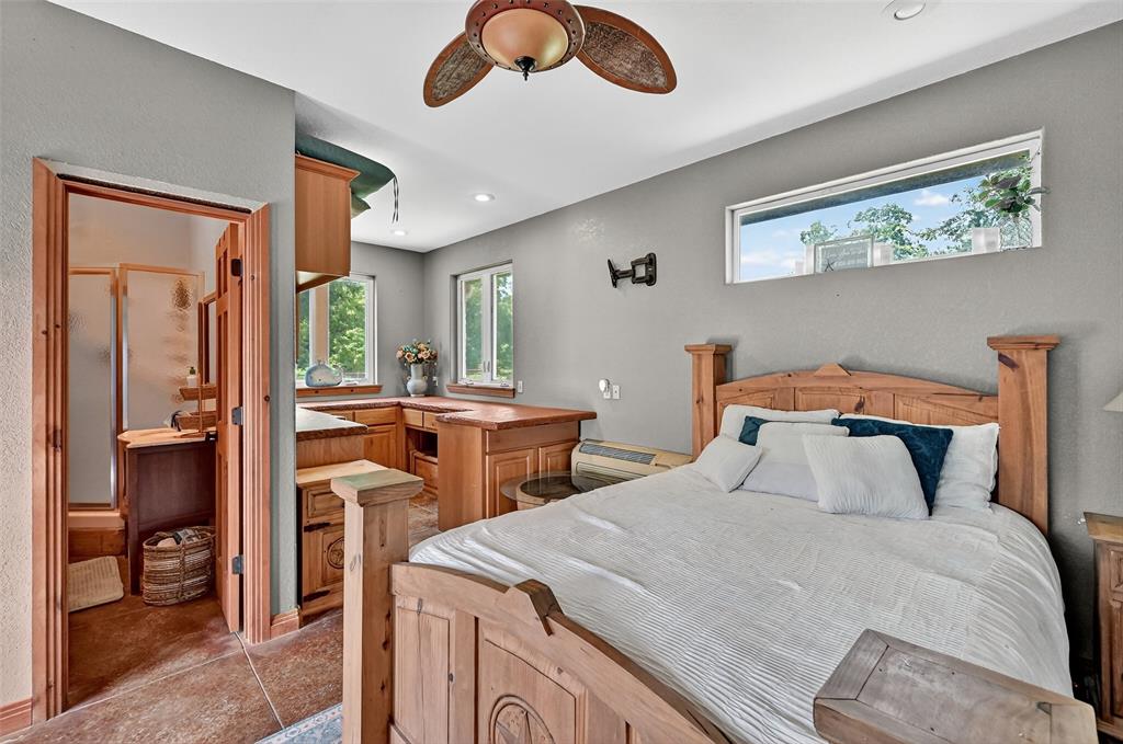 1717 Batey Road Collinsville, TX 76233 - Photo 30 of 40 a bedroom with a bed and a chandelier