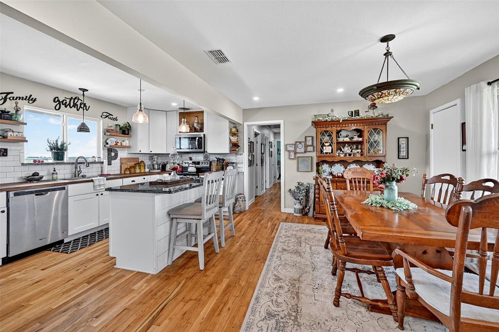 1717 Batey Road Collinsville, TX 76233 - Photo 39 of 40 a kitchen with granite countertop lots of counter top space and stainless steel appliances