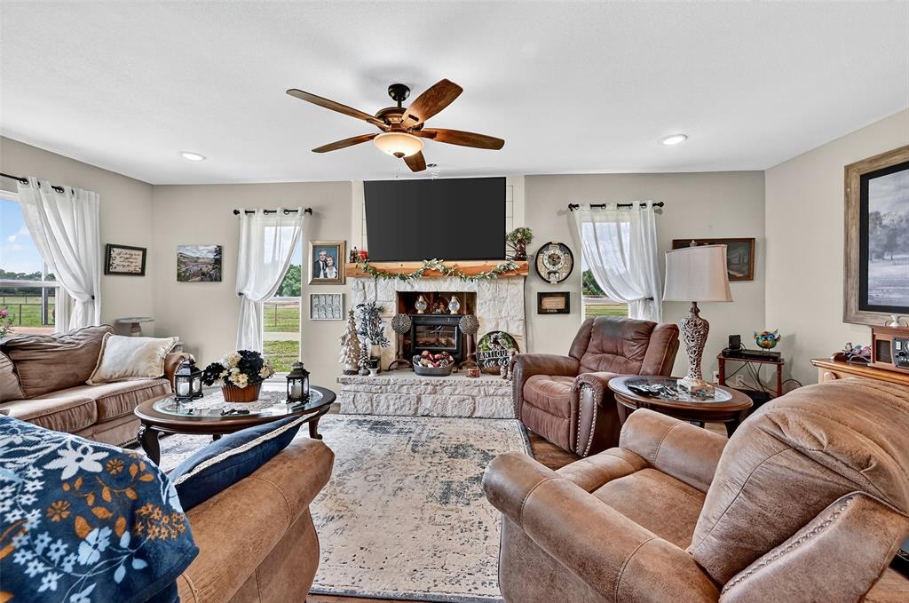 1717 Batey Road Collinsville, TX 76233 - Photo 40 of 40 a living room with furniture a flat screen tv and a fireplace