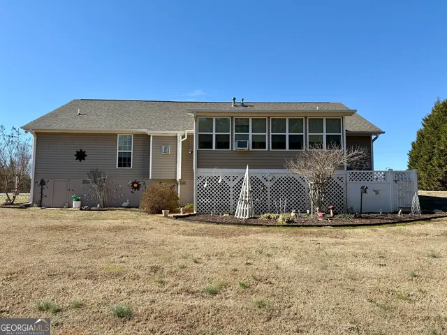 a backyard of a house with barbeque oven table and chairs