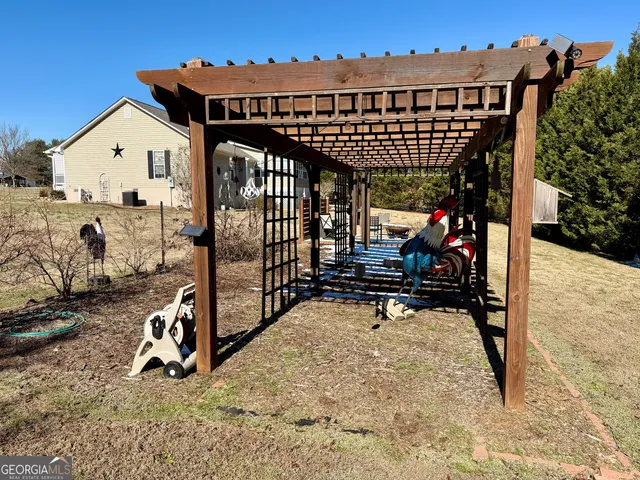 a view of a patio with table and chairs with wooden floor and fence