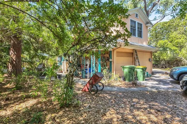 a view of a house with backyard porch and sitting area