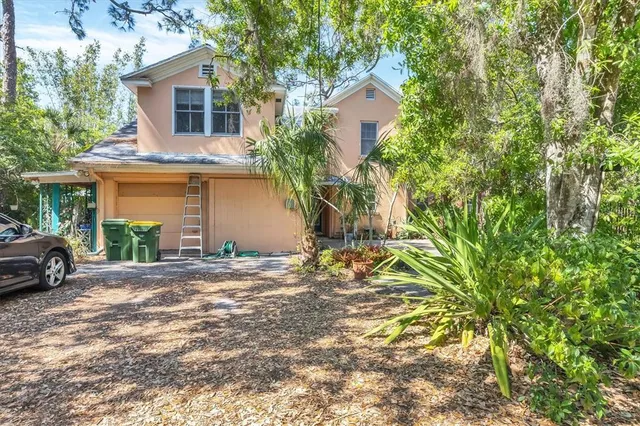 a view of a house with a yard and garage
