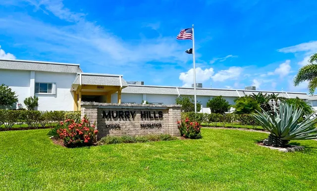 a view of a swimming pool with a table and chairs