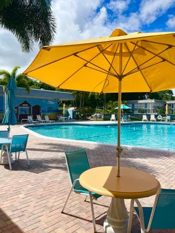 a room with pool table and windows