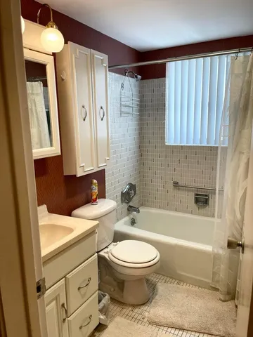 a bathroom with a toilet a sink and bathtub