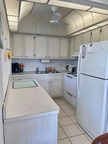 a kitchen with a refrigerator a sink and a stove