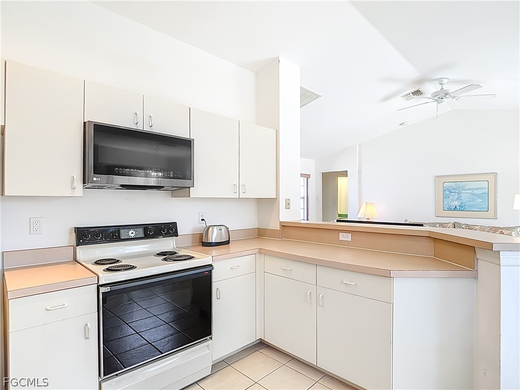 2160 Faliron Road North Fort Myers, FL 33917 - Photo 15 of 42 a kitchen with a sink stove and microwave