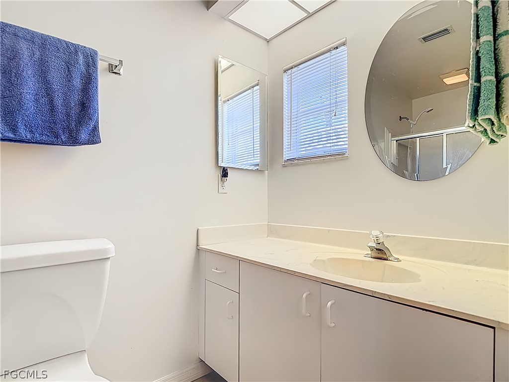 2160 Faliron Road North Fort Myers, FL 33917 - Photo 19 of 42 a bathroom with a sink toilet and mirror