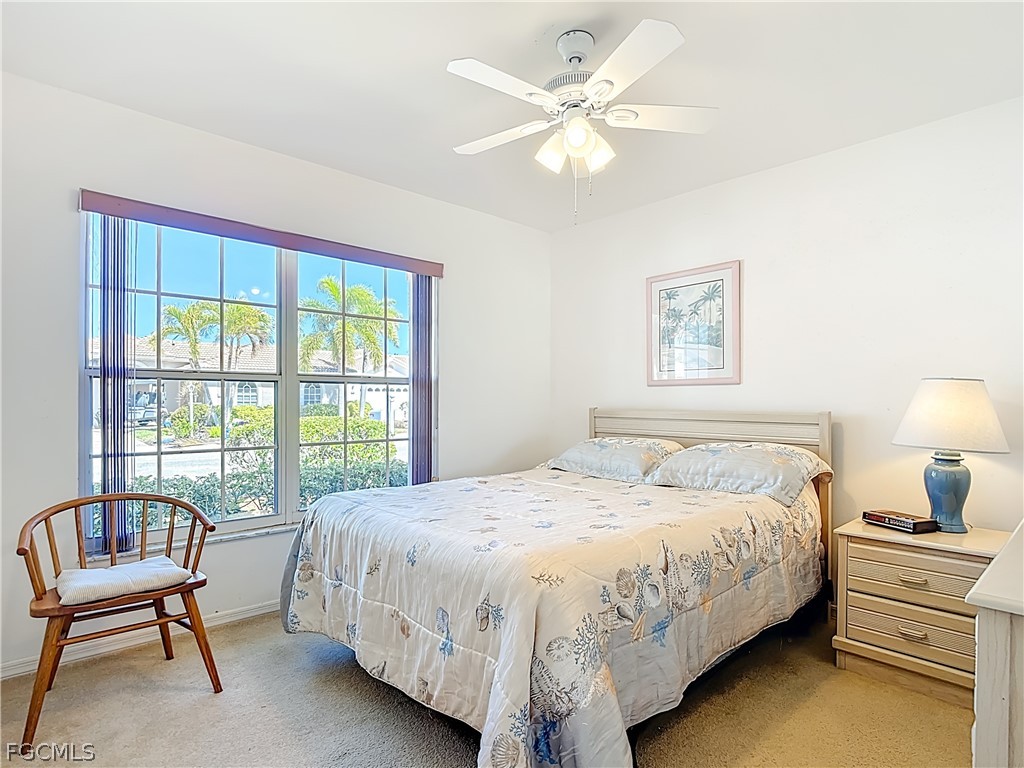 2160 Faliron Road North Fort Myers, FL 33917 - Photo 20 of 42 a bedroom with a bed a chandelier and a window