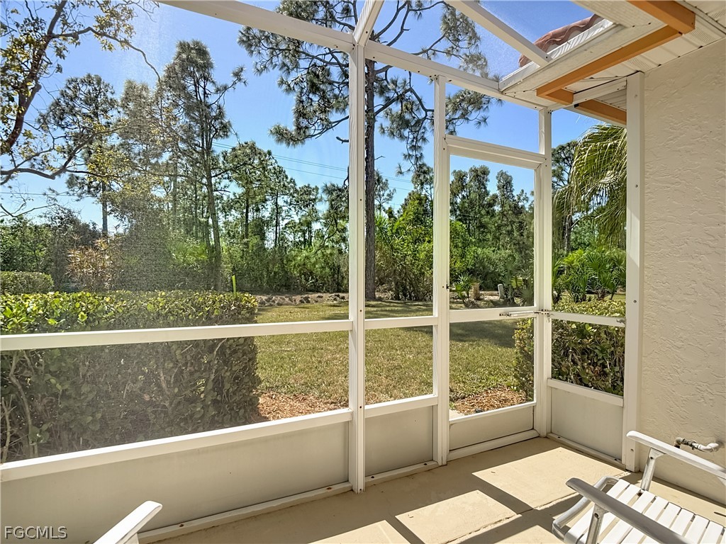 2160 Faliron Road North Fort Myers, FL 33917 - Photo 24 of 42 a view of a porch with a floor to ceiling window next to a yard