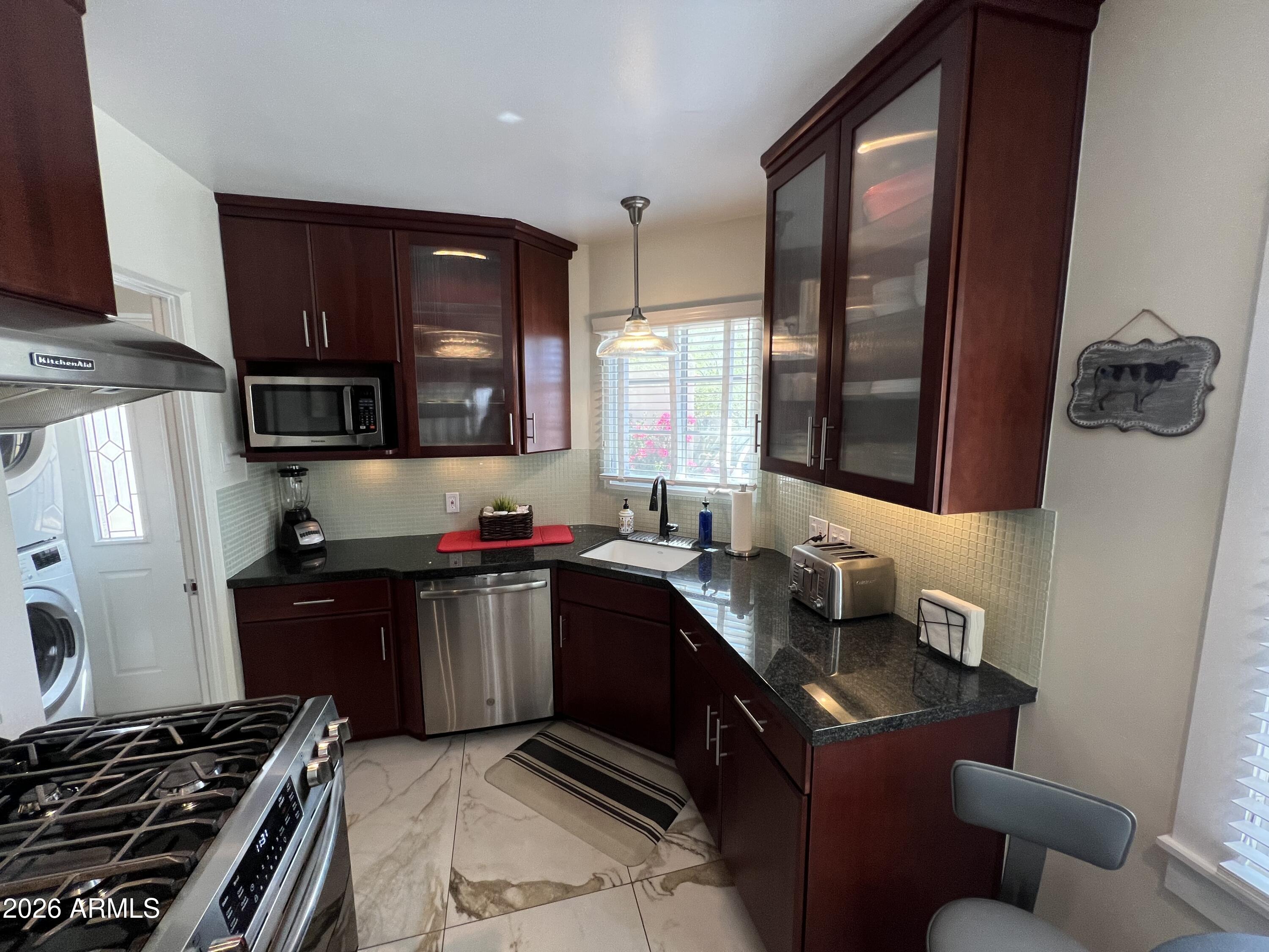 1326 East Coronado Road Phoenix, AZ 85006 - Photo 9 of 36 a kitchen with a sink and a stove top oven