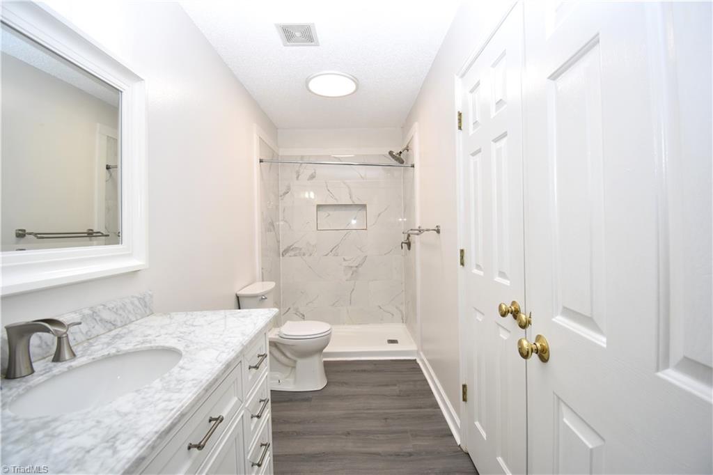 2553 Stratford Lake Road Winston-Salem, NC 27103 - Photo 10 of 19 The private en-suite also access the primary bedroom closet.