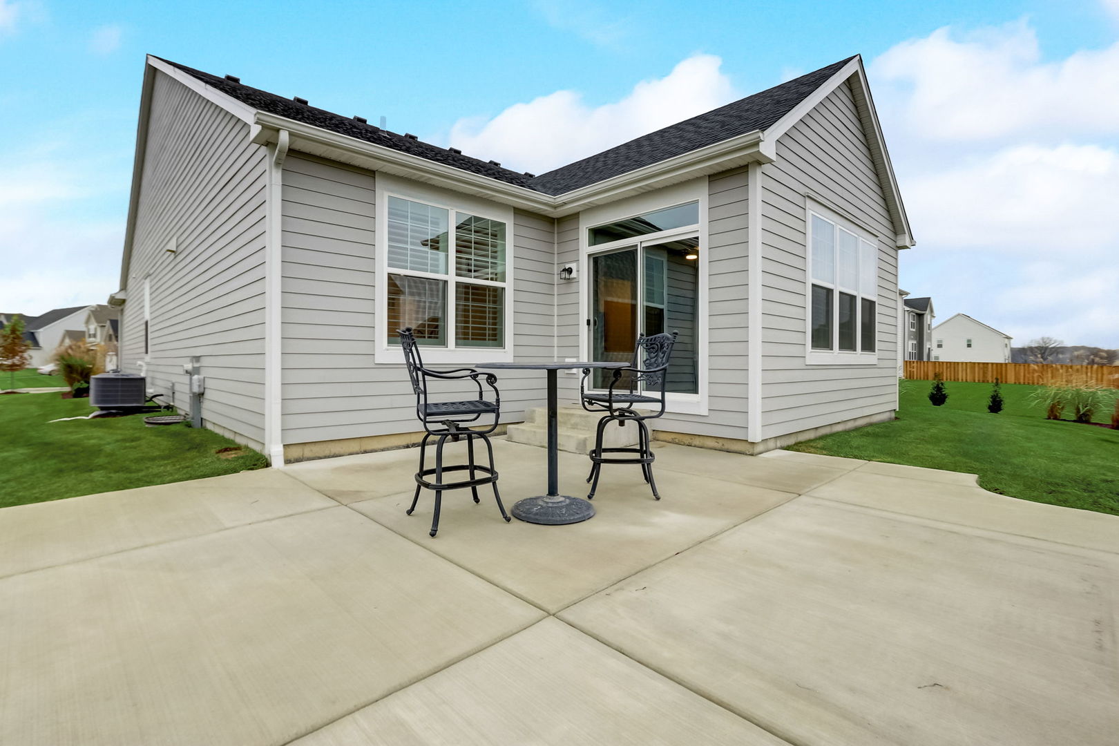 3630 Edelweiss Road Elgin, IL 60124 - Photo 39 of 47 a patio with a table and chairs and a yard