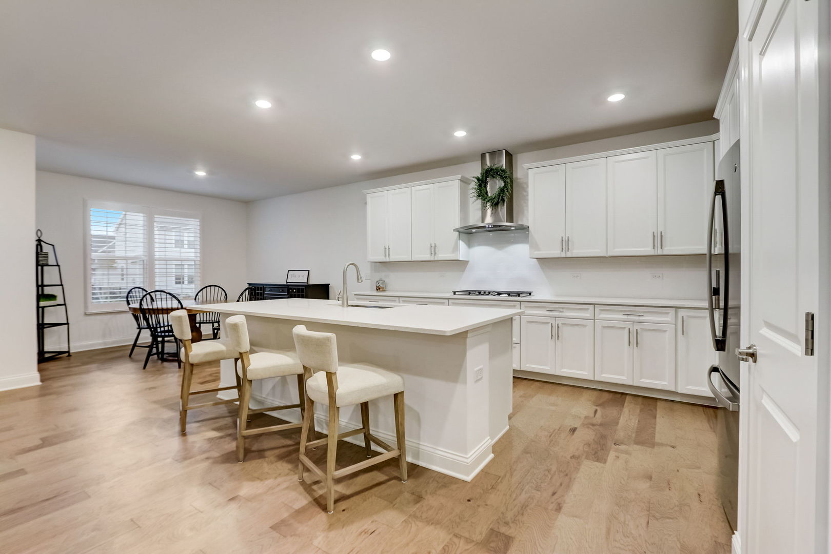 3630 Edelweiss Road Elgin, IL 60124 - Photo 8 of 47 a kitchen with white cabinets and chairs