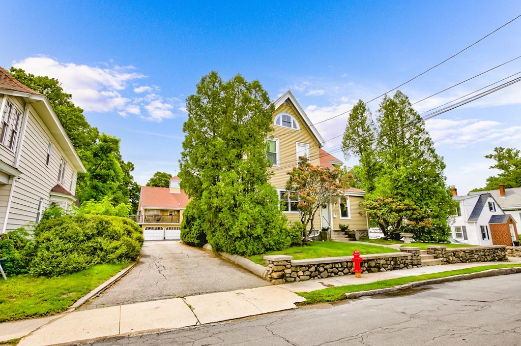 28 Stevens Street, Unit B Methuen, MA 01844 - Photo 4 of 11 a front view of a house with a yard and garage