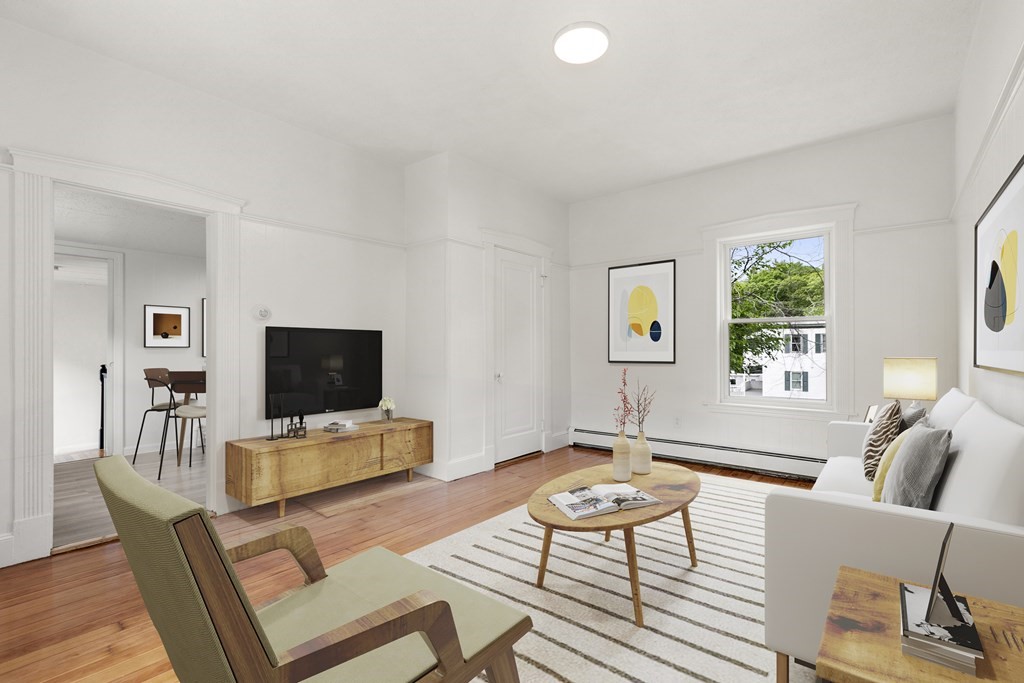 28 Stevens Street, Unit B Methuen, MA 01844 - Photo 5 of 11 a living room with furniture and a flat screen tv