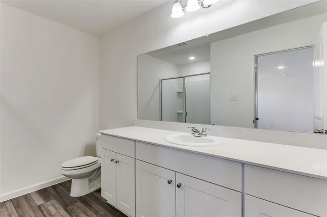 a bathroom with a glass shower door