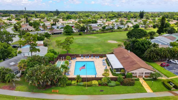 an aerial view of residential houses with outdoor space and street view