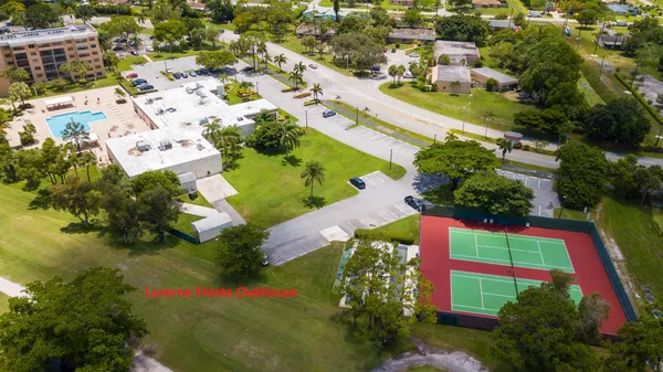an aerial view of residential building with outdoor space and trees