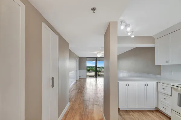 a view of hallway with wooden floor