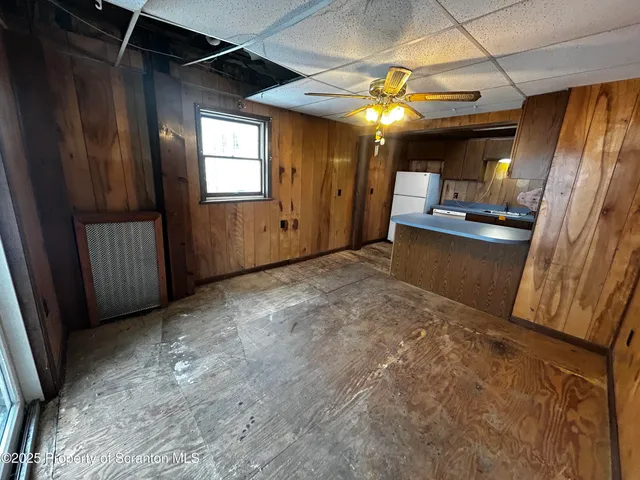 a view of a hallway with furniture